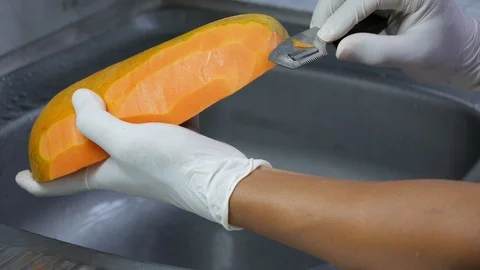 Peel the ripe papaya with a sharp knife Stock Footage 89224011
