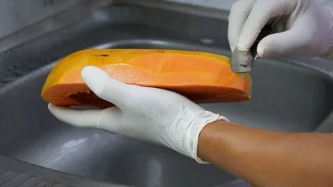 Peel the ripe papaya with a sharp knife Stock Footage 89224028