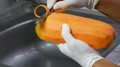 Peel the ripe papaya with a sharp knife Stock Footage 89225467