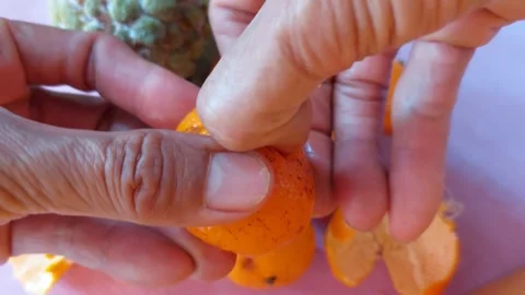 Peel a small orange Stock Footage 265592374