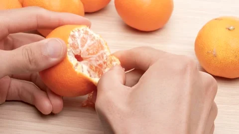 Peel the tangerines. Stock Footage 293747473