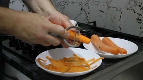 Peel vegetables with a vegetable peeler Stock Footage 336209599