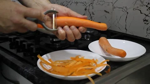 Peel vegetables with a vegetable peeler Stock Footage 336209620