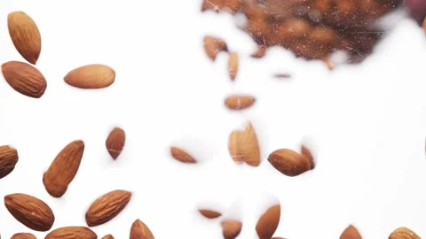 Peeled almonds falling on white background Stock Footage 155507216