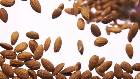 Peeled almonds falling on white background Stock Footage 156201473