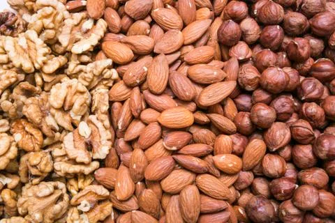 Peeled almonds, hazelnuts and walnuts kernel background or texture Stock Photos