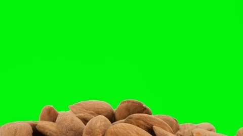 Peeled almonds isolated on green background, rotating (loopable) Stock-Footage 88808697