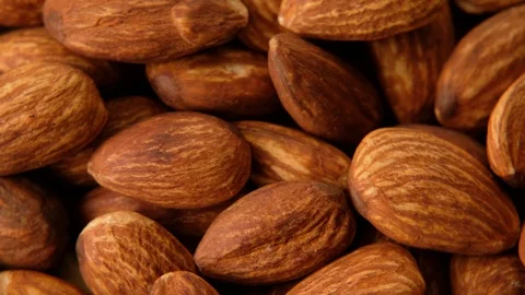Peeled almonds nuts closeup rotating, macro shot Stock Footage 125603304
