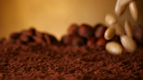 Peeled almonds splash into cocoa - close up, slow motion Video stock 104464183