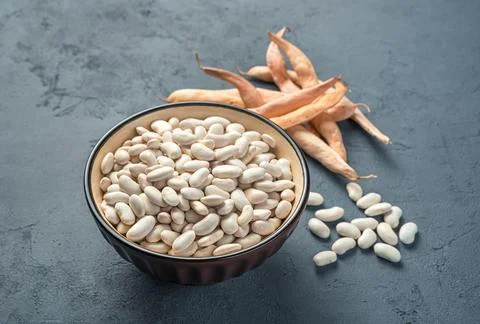 Peeled beans and in pods on a graphite background. Stock Photos