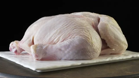 Peeled broiler chicken on a black background Stock Footage 132878149