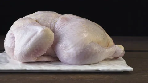 Peeled broiler chicken on a black background Stock Footage 132881541