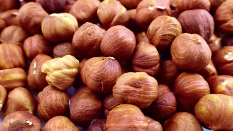Peeled brown hazelnuts circle rotation close up Stock Footage 233034809