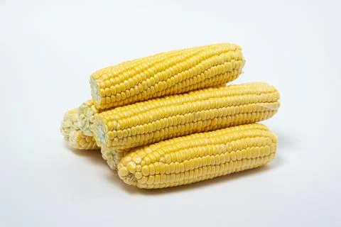 Peeled corn on a white background. Raw fresh corn.  Stock Photos