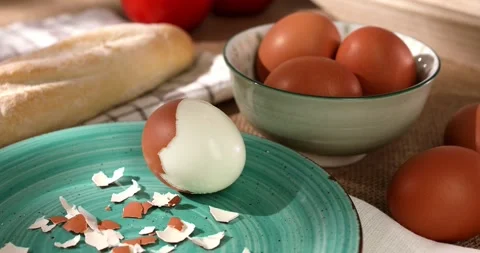 Peeled egg on a plate. boiled chicken eggs with bread and tomatoes. Stock Footage 241220934