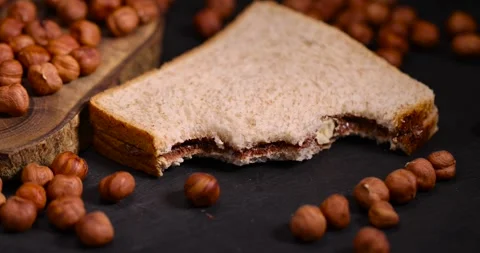 Peeled fresh hazelnuts and bread with nut paste with chocolate, delicious and Stock Footage 288718981