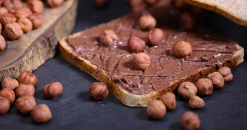 Peeled fresh hazelnuts and bread with nut paste with chocolate, delicious and Stock Footage 289418439
