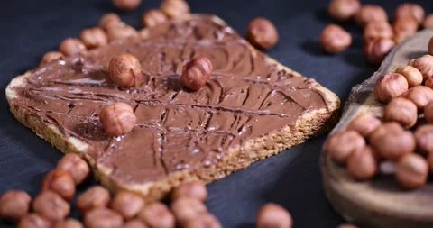 Peeled fresh hazelnuts and bread with nut paste with chocolate, delicious and Stock Footage 289922319