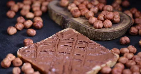 Peeled fresh hazelnuts and bread with nut paste with chocolate, delicious and Stock Footage 292761547
