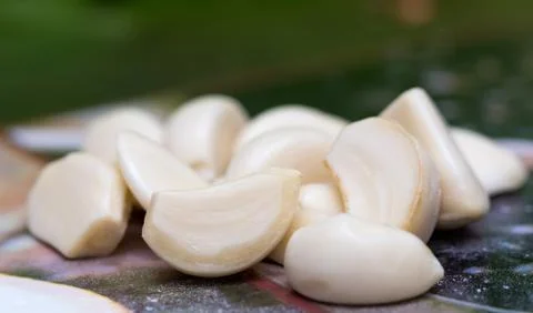 Peeled garlic on the table Stock Photos