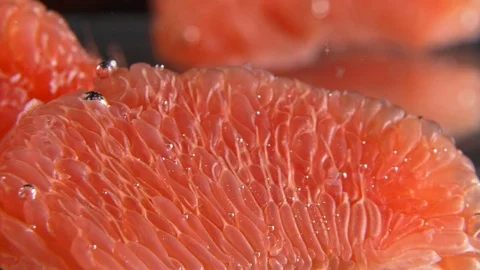 Peeled Grapefruit slice falling in water macro Stockbeeldmateriaal 122257181