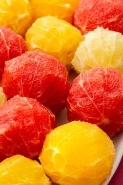 Peeled grapefruits, oroblancos and oranges Stock Photos