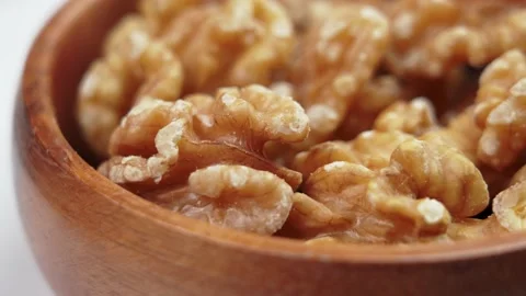 Peeled half fresh walnut in rustic wooden bowl Stock Footage 221747525