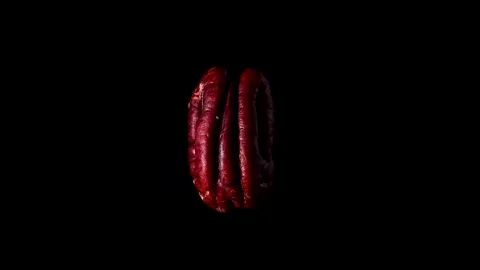 Peeled half pecan nut rotate isolated on black background slow motion video 360 Stock Footage 256793789