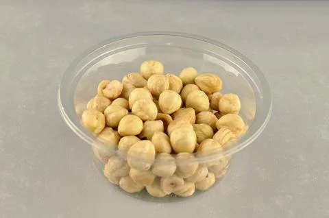 Peeled hazelnuts in a transparent plastic package Stock Photos