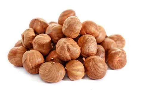 Peeled hazelnuts on a white background. Isolated hazelnut. Without shells. Stock Photos