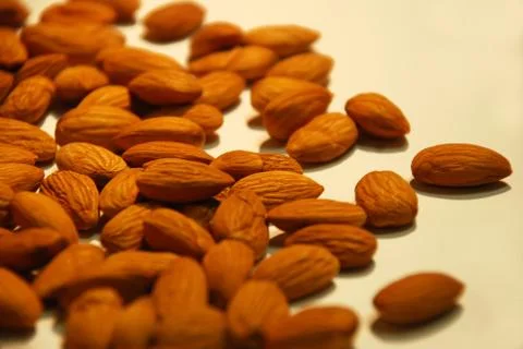Peeled kernel almonds in bulk close up in bulk as background Stock Photos