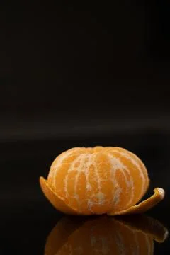 Peeled Mandarin with Reflection on Black Background Stock Photos