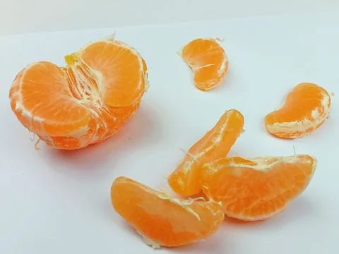 Peeled mandarin with segments on white background Stock Photos