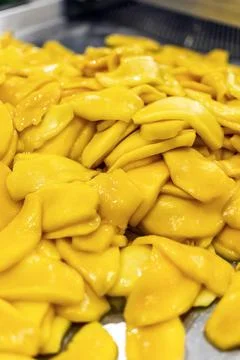 Peeled mango fruit processing at food production factory in cambodia Stock Photos