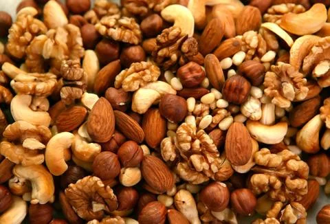Peeled nuts in bulk as background: walnut and almonds, cashews Stock Photos