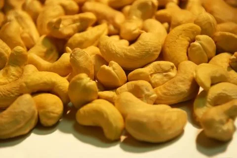 Peeled nuts cashews in bulk as background Stock Photos
