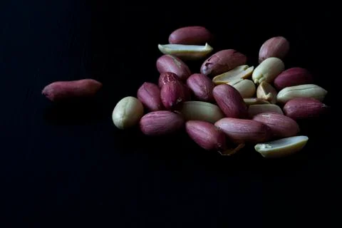 Peeled nuts on a dark background Foto stock