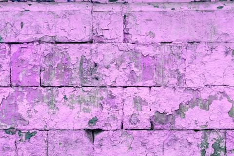 Peeled off old violet paint on flat rough brick wall surface - full frame Fotos Stock