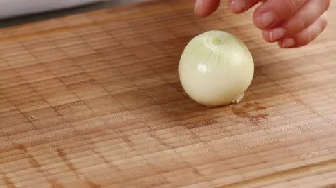 A peeled onion being cut into eighths Stock Footage 24672637