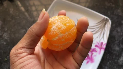 Peeled Orange Fruit Held in Hand Close-Up View Stock-Footage 320931001
