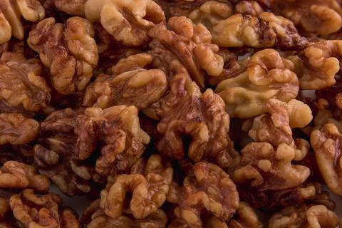 Peeled organic fresh walnuts pattern close up top view Stock Photos