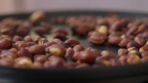 Peeled peanuts are being roasted. A heap of peanuts are being cooked, fresh Video stock 306061957