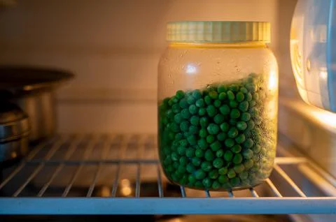 Peeled Peanuts kept in plastic tin and it stored in refrigerator Stock Photos