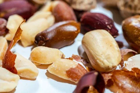 Peeled peanuts on a light surface. Stock Photos