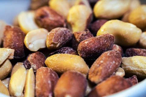 Peeled peanuts on a light surface. Stock Photos