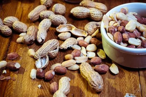 Peeled peanuts on a light surface. Stock Photos