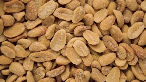 Peeled peanuts in powder rotate on the surface. Top view Stock Footage 142033431