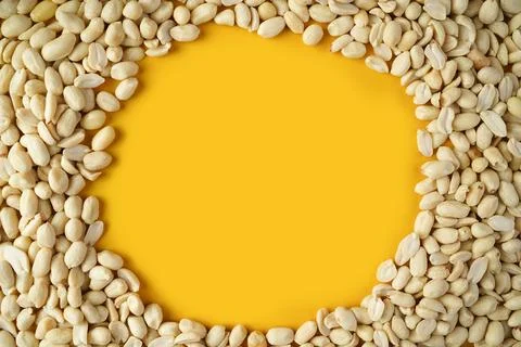 Peeled peanuts on yellow background, circle shape in nuts 스톡 사진