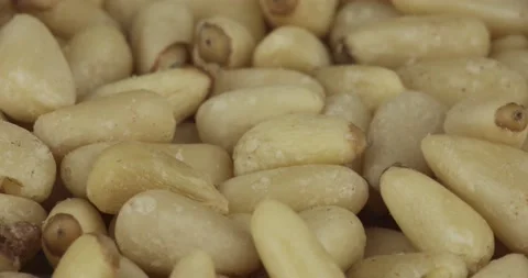 Peeled pine nuts closeup rotating selective focus Stock Footage 161412850
