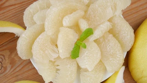 Peeled pomelo on a plate. Stock Footage 243160128